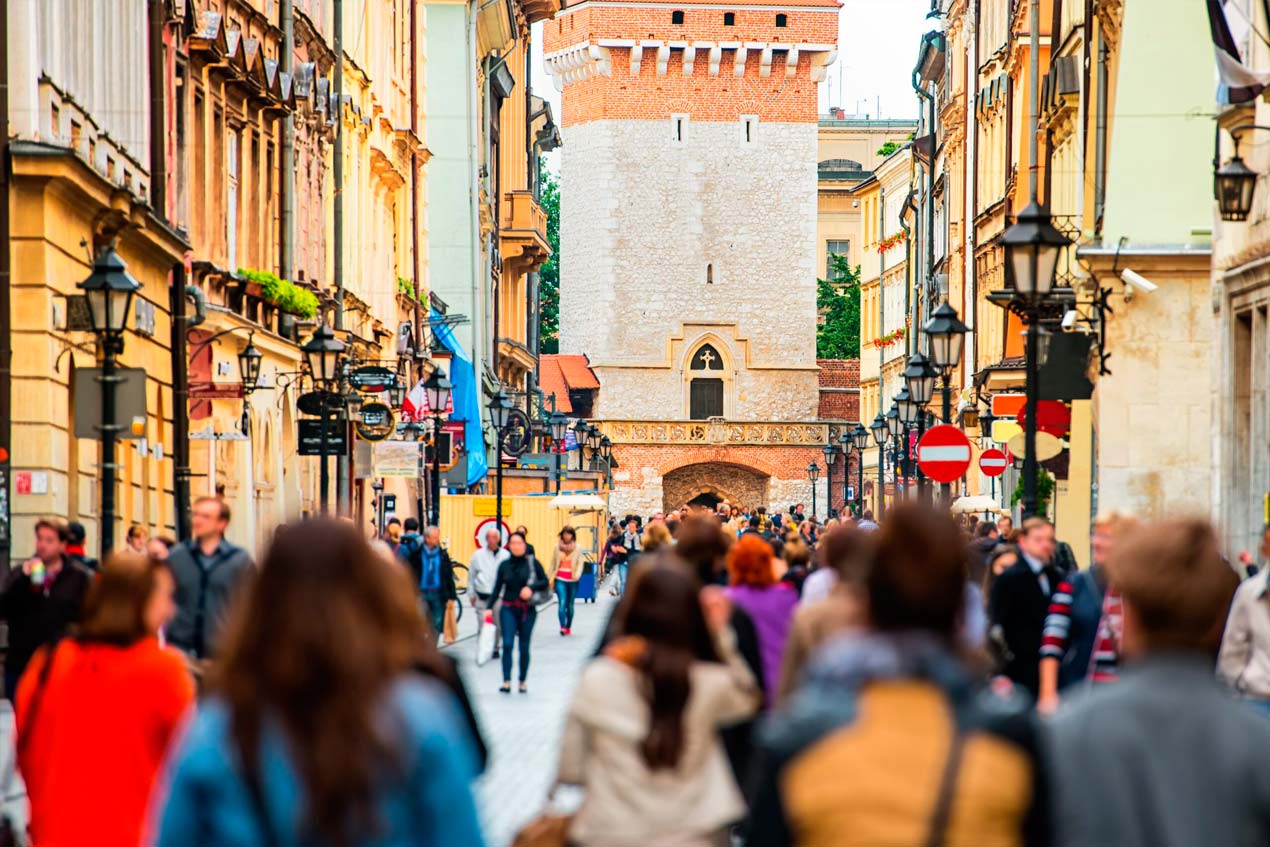 Crowd of anonymous people walking on a busy street. Krakow, Old Town, Poland.